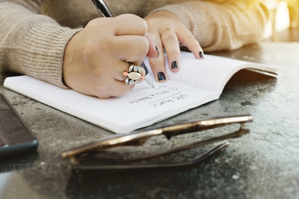 View Of Female Hands Writing Her Life Goals In A Journal